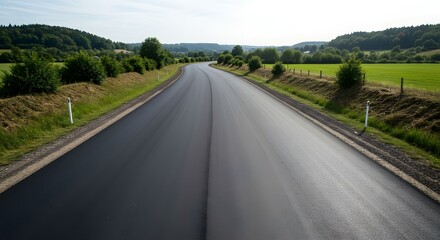 Long Asphalt Road Winding Through Scenic Countryside Landscape Under Bright Daylight, Embracing Nature's Beauty and Inviting Exploration and Adventure