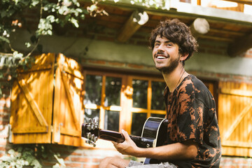 Man playing guitar in rustic setting in La Paloma