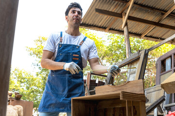 Carpenter man using measuring tape working in carpentry workshop