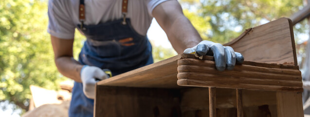 Banner unknown carpenter doing diy furniture in carpentry workplace