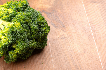Raw fresh broccoli on old wooden table