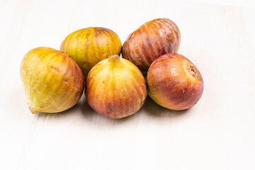 Freshly ripe figs. Healthy Mediterranean fig fruit. Fresh figs on a dark background. Beautiful blue violet figs with leaves, copy space, closeup