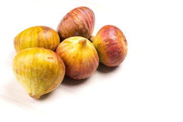 Freshly ripe figs. Healthy Mediterranean fig fruit. Fresh figs on a dark background. Beautiful blue violet figs with leaves, copy space, closeup