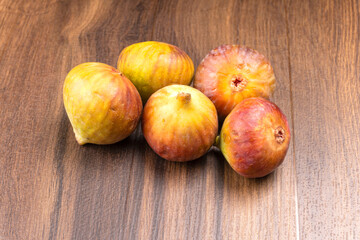 Freshly ripe figs. Healthy Mediterranean fig fruit. Fresh figs on a dark background. Beautiful blue violet figs with leaves, copy space, closeup
