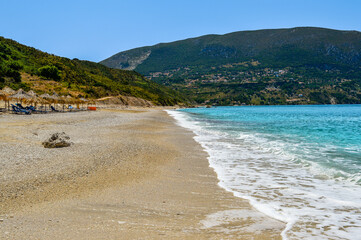 Agia Kyriaki beach near Zola in Kefalonia, Greece, with straw umbrellas and turquoise sea, peaceful...
