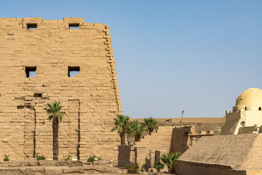 Pylon of the facade of the temple of Karnak, Luxor, Egypt, dedicated to the god Amon Ra. Blue sky on the right.