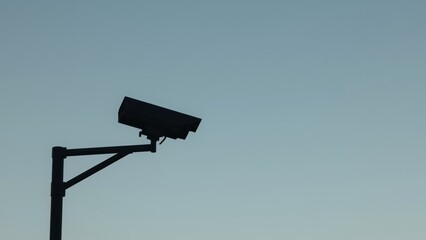 Home Security Camera. Black surveillance camera silhouette on pole dur