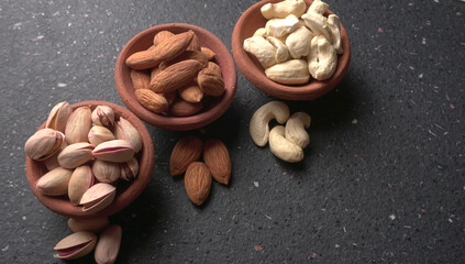 Pistachios or Pista nuts decorated with green leaves. plain background, top view.Flat lay.