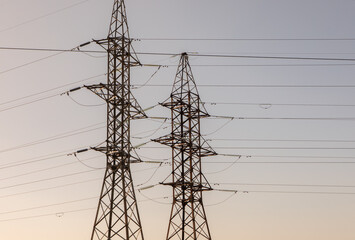 High voltage power lines and pylons against blue sky. Electric tower. Power transmission lines....