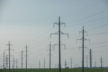 High voltage power lines and pylons against blue sky. Electric tower. Power transmission lines....
