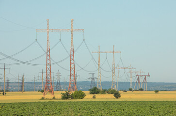 High voltage power lines and pylons against blue sky. Electric tower. Power transmission lines....