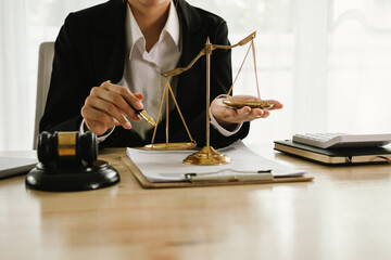 A professional lawyer sits at a desk surrounded by legal books, documents, and a gavel, providing...
