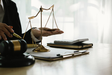 A professional lawyer sits at a desk surrounded by legal books, documents, and a gavel, providing legal advice, studying contracts, and preparing for courtroom proceedings.