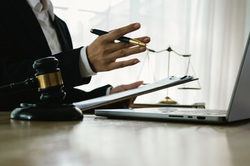 A professional lawyer sits at a desk surrounded by legal books, documents, and a gavel, providing...