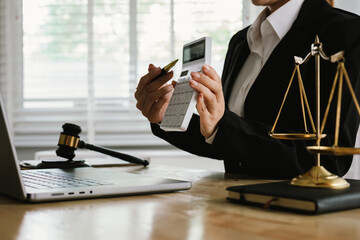 A professional lawyer sits at a desk surrounded by legal books, documents, and a gavel, providing...