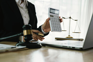 A professional lawyer sits at a desk surrounded by legal books, documents, and a gavel, providing...
