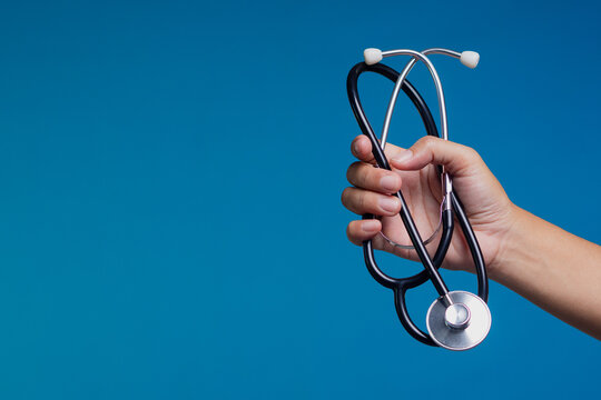 Close-up of stethoscope held in hand symbolizing medical care, diagnosis, and clinical support.