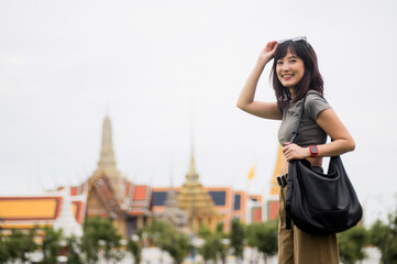 Happy solo southeast asian woman teenager blogger on world travel journey. smiling explorer...