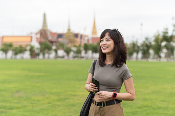 Happy solo Southeast Asian woman young teenager blogger and world travel explorer enjoying local...