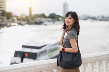 Happy southeast asian teenager solo world travel explorer blogger on tourism trip in Asia. local...