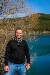 Portrait of a Man by the Beautiful Lake Doxa in Corinth, Greece, with Blue Waters, Green Hills and...