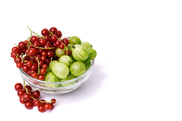 Glass bowl with fresh red currants and gooseberries on white background. Summer berry mix, isolated, healthy eating concept.