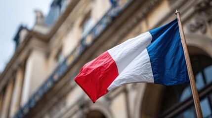French national flag waving in front of classic Parisian architecture with blurred historical facade in background perfect for patriotic visuals, travel content and cultural editorials