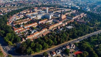 Aerial panoramic view around the old town of the city Neubrandenburg on a sunny noon in summer in Germany.