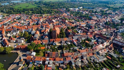 Aerial panoramic view around the old town of the city Teterow on a sunny noon in summer in Germany.