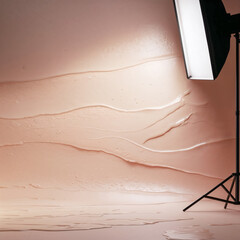 Professional Photography Studio Setup with Beige Backdrop and Studio Lighting Equipment for Commercial Photo Shoots