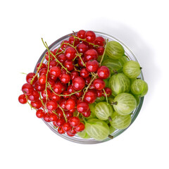 Glass bowl with fresh red currants and gooseberries on white background. Summer berry mix, dessert,...