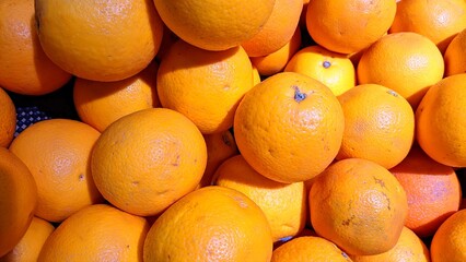 Group of fresh oranges arranged in a market stall, symbolizing freshness, vitamins, and organic fruit