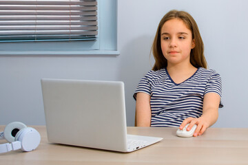 Teenage girl concentrating while working on laptop