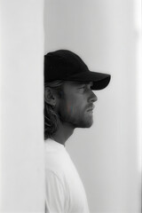 portrait of skateboarder lost in thought positioned on left side of frame with clean ultrabright background