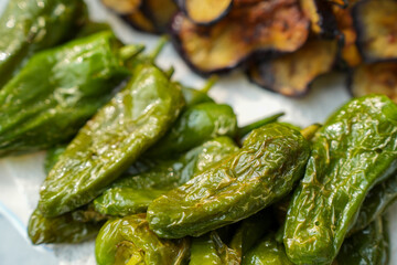 Fried Pimientos de Padron - green pepper-  and eppglants  on a Plate