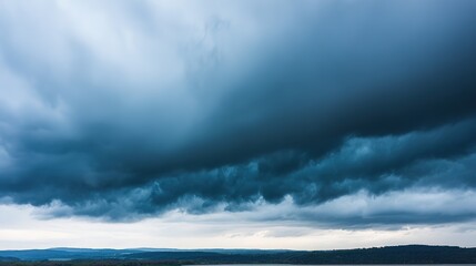 Dramatic storm clouds in deep blue, a sweeping skyscape with dynamic light, nature's raw power on display