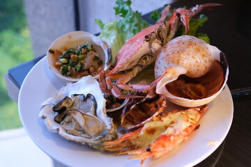 table set with assorted appetizers, seafood, and pastries for a festive meal