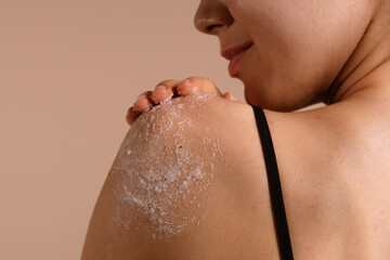 Woman Gently Exfoliating Shoulder with Body Scrub, Close-up View