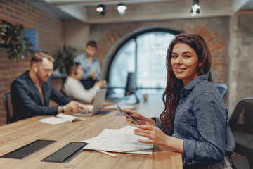 A diverse and talented group of skilled professionals is actively collaborating in a modern,...