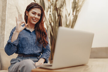 A woman joyfully enjoys a video call, highlighting the significance of connectivity and remote...