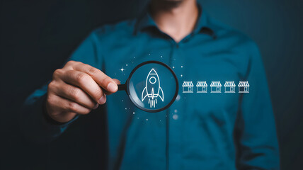 Launching franchise expansion with magnifying glass focusing on startup rocket and future storefronts, symbolizing growth and new opportunities.