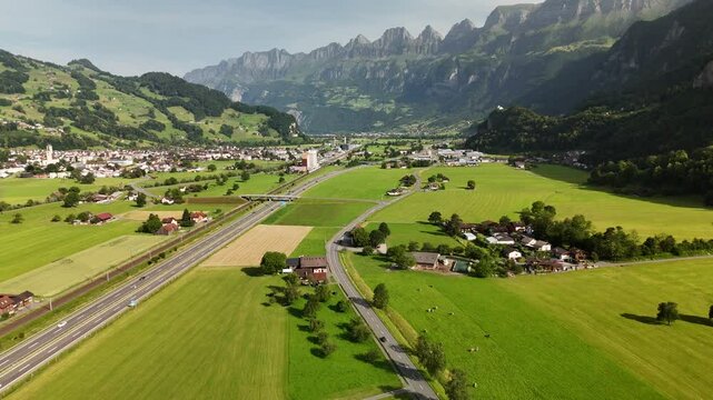 Scenic Aerial View of a Valley with Green Fields and Mountain Landscape in Switzerland near Flums, Berschis, and Walenstadt in the Canton of St. Gallen &ndash; Drone Footage
