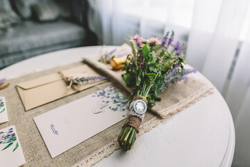 Close-up of rustic bridal bouquet and botanical stationery on linen table, embracing romantic...