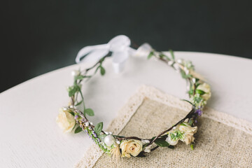 Handmade bridal floral crown with pearls on rustic table. Perfect for wedding themes, slow lifestyle, romantic mood, boho chic or natural elegance concepts.
