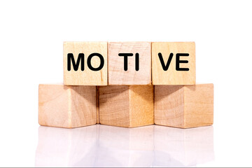 The concept word MOTIVE is assembled from wooden cubes. business motivational concept