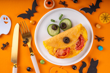 Halloween breakfast eggs omelet in form of monster
