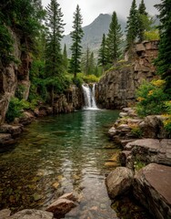 Serene mountain landscape featuring a tranquil pool surrounded by lush greenery and a cascading waterfall under a cloudy sky