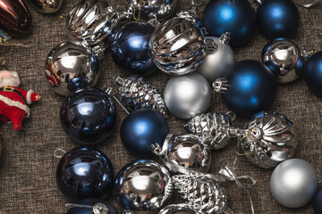 Christmas tree decorations are lying on the sofa. Preparing for the holiday, or after Christmas.