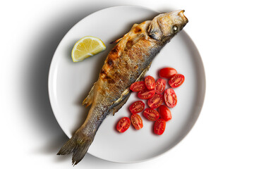 Plate with grilled sea bass and tomatoes and lemon