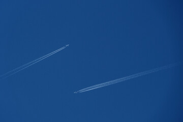 airplane trail in the blue sky, two planes in the sky, two airplane tracks in the blue sky, contrails